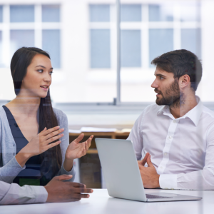 image shows open communication between two employees, reducing stress in the workplace